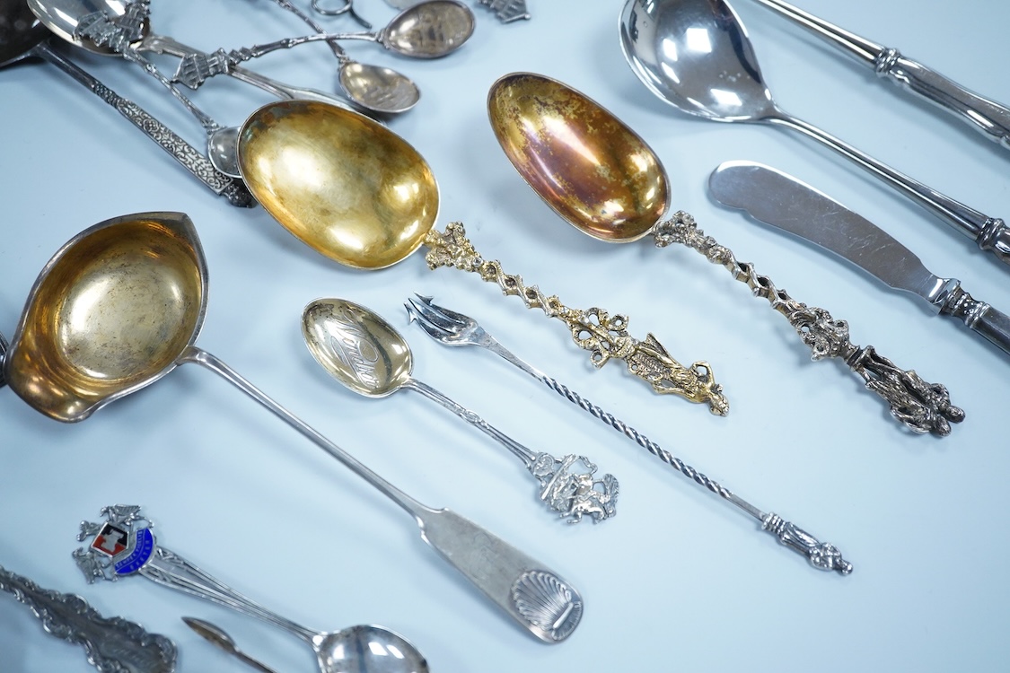 A small quantity of assorted 19th century and later silver and white metal flatware, including teaspoons, commemorative spoons, ladles, sugar tongs, pickle fork, a pair of Swedish salad serves, a similar butter knife and
